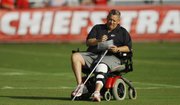 Kansas City Chiefs offensive coordinator Charlie Weis looks over notes in this July 30 file photo from training camp in St. Joseph, Mo.