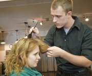 Jake Masters, Parkville, Mo., an apprentice cosmetologist at Z’s Cosmetology Academy, prepares to do a coloring with client Katelyn Anderson, Lawrence. Masters will graduate from Z’s in December.