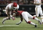 Kansas City Chiefs running back Tim Castille, left, is upended by Atlanta’s Christopher Owens. The Falcons beat the Chiefs, 20-10, on Friday in Atlanta.