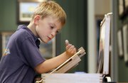 Kieron Williamson, an 8-year-old painting prodigy, works on a drawing in Holt, Norfolk, in England. He’s Britain’s most talked-about young artist, and his paintings sell for thousands of dollars.
