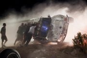 Workers push an overturned off-road race truck upright after it went out of control and ran into a crowd of spectators during a race Saturday in Lucerne Valley, Calif. Eight people were killed during the incident about 100 miles east of Los Angeles.