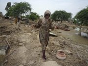 Pakistani flood survivors return to their village devastated by heavy floods Monday in Dera Ismail Khan, Pakistan. A forecast of more flooding has increased the urgency of the massive international relief effort.