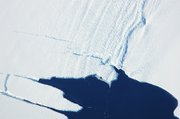 A massive sheet of ice prepares to break off the Pine Island Glacier of Antarctica. The ice appearing above the surface of the ocean is roughly 50 meters thick.