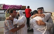 Family members of Saif Ali, 24, grieve Tuesday during his funeral in Najaf, south of Baghdad. Ali was killed when a suicide bomber sat for hours Tuesday among hundreds of army recruits before detonating nail-packed explosives strapped to his body, killing and wounding dozens of them and casting new doubt on the ability of Iraqi forces as U.S. troops head home.