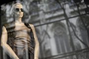 A mannequin is displayed Saturday in the window of the Saks Fifth Ave flagship store on New York’s Fifth Ave. Upscale department store Saks Inc. said Tuesday its second-quarter loss narrowed as margins improved because it was able to sell more products at full-price and rely less on sales.