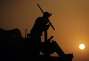 A U.S Army soldier dismantles a machine gun mounted on his Stryker armored vehicle Monday, immediately after crossing the border from Iraq into Kuwait. The U.S. Army’s 4th Battalion, 9th Infantry Regiment, part of the 4th Brigade, 2nd Infantry Division, are the last combat brigade to leave Iraq as part of the drawdown of U.S. forces.