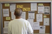 A job seeker checks for new job postings Thursday at Glendale Workforce Services Center in Glendale, Calif. Employers appear to be laying off workers again as the economic recovery weakens. The number of people applying for unemployment benefits reached the half-million mark last week for the first time since November.
