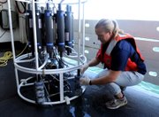 Hydrographer Rachel Medley takes a sample from a water column sampler that was recovered from the Gulf of Mexico on Friday on board the NOAA Ship Pisces about 9 miles south of the Deepwater Horizon oil wellhead near the coast of Louisiana. New guidelines were released Friday that hinted that those closest to the oil might have the best chance of winning an emergency claim.