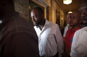 Haitian-born singer and presidential hopeful Wyclef Jean, second left, walks surrounded by security after Haiti’s Electoral Council rejected his candidacy Friday in Port-au-Prince, Haiti.