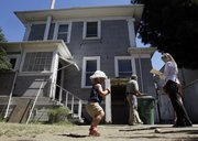 Pacific Union International agent Sheila Gallagher, at right, takes notes Tuesday during inspection of a home she recently sold in Alameda, Calif. Abbey Hange, 18-month-old daughter of the new homeowner, is pictured at left.