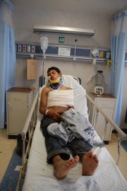 Ecuadorean citizen Luis Fredy Lala Pomavilla rests Tuesday at a hospital in Matamoros, eastern Mexico. A Mexican drug cartel massacred 72 Central and South American migrants within 100 miles of the U.S. border that they were trying to reach, according to Lala Pomavilla who said he escaped and stumbled wounded to a highway checkpoint where he alerted marines.