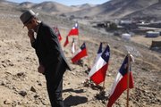Ramon Avalo, 81, wipes tears Saturday after seeing the names of his two grandsons, miners Renan and Florencio Avalo, written on Chilean flags at a camp where the relatives of 33 trapped miners wait outside the collapsed San Jose mine in Copiapo, Chile.