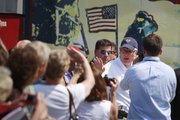 By a image of Neil Armstrong, Glenn Beck, right, waves to supporters Friday at the site of the Restoring Honor rally by the Lincoln Memorial in Washington. The rally will take place today.