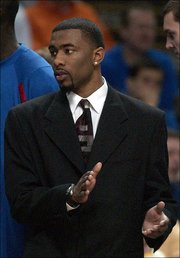Senior Keith Langford sports a suit and tie, instead of a jersey, during KU's Big 12 tournament semi-final game with Oklahoma State Saturday, March 12, 2005 at Kemper Arena in Kansas CIty. Langford was battling a bad reaction to painkillers which was causing his kidneys to shut down.