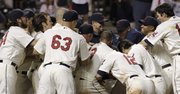 Cleveland players mob Asdrubal Cabrera after Cabrera hit the game-winning solo home run in the 10th inning in a 4-3 victory over the Royals on Saturday in Cleveland.