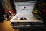 Meredith Guy, 5, of Metairie, La., looks into a “Katrina casket,” where people placed notes and items, after an ecumenical “funeral” for Hurricane Katrina at Our Lady of Prompt Succor Catholic Church in Chalmette, La., one day before the fifth anniversary of the storm.