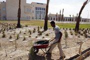A landscaper works on the grounds of a children’s hospital earlier this month in Basra, Iraq’s second-largest city, 340 miles southeast of Baghdad. The $165 million hospital has yet to open because of problems connecting to the electricity grid. This site is among hundreds of projects funded by U.S. taxpayers that remain abandoned or incomplete, wasting more than $5 billion, according to auditors.