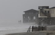 Wind and waves move in near beachfront houses Thursday in Nags Head, N.C., as Hurricane Earl moves up the East Coast. The hurricane began to lash North Carolina’s dangerously exposed Outer Banks on Thursday night. Gusts above 40 mph made signs shake and heavy rain fell. See the story on page 2A.