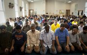 Men kneel for afternoon prayer on Friday, Sept. 3, 2010, at the Islamic Center of Lawrence. Many Muslims in Lawrence say the city’s diverse cultural makeup makes it very accepting of different faiths.