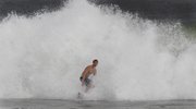 R.J. Smith rides a wave while surfing Thursday in Ocean City, Md., as Hurricane Earl heads toward the East Coast.
