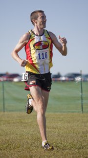 Unattached runner and former KU cross country star Paul Hefferon, gives a thumbs up to the crowd as he finishes first at the Bob Timmons Classic, Saturday, Sept 4, 2010.