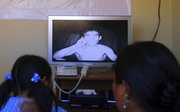 Trapped miner Claudio Yanez talks to his relatives during a video conference at the collapsed San Jose mine in Copiapo, Chile, in this photo provided by Chile’s government. Thirty-three miners have been trapped deep underground in the copper and gold mine since it collapsed Aug. 5.
