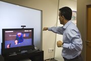 Israeli Uzi Breier, employee of PrimeSense, uses his hands to control a screen June 21 in the company offices in Tel Aviv. Controlling your surroundings with the wave of a hand sounds like magic, but PrimeSense is already making headway, thanks to a little help from video games.