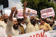 Pakistani protesters rally Thursday in reaction to a small American church’s plan to burn copies of the Quran in Multan, Pakistan. The plans are currently suspended.