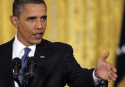 President Barack Obama gestures during a news conference Friday in the East Room of the White House.