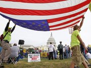 People gather at the U.S. Capitol for a “Remember in November” rally to express opposition to government spending, particularly bailouts and economic policies backed by President Barack Obama and Democrats in Congress, Sunday in Washington. Tea party rallies were also held Sunday in St. Louis and Sacramento, Calif.