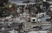 A man walks past the remains of homes damaged from a fire caused by a rupture in a natural gas line in a mostly residential area Monday in San Bruno, Calif. The explosion prompted California regulators to order the utility, Pacific Gas and Electric, to survey all its natural gas lines in the state in hopes of heading off another disaster.