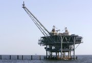 A natural gas platform is shown off the coast of Fort Morgan, Ala., in this file photo taken April 13, 2007. America’s ban on offshore drilling was meant only for the deep water, yet rules created in the wake of the BP disaster appear to have halted numerous projects at safer depths where most of the industry works.