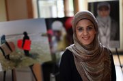 Photojournalist and author Sadaf Syed, seen in her Willowbrook, Ill., home earlier this month with photos from her book, just released “iCover: A Day in the Life of a Muslim-American COVERed Girl,” which looks at American Muslim women who wear the hijab.