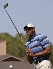 Wayne Simien tees off on the first hole to kick off the Family Promise of Lawrence golf tourney Monday at Alvamar Country Club.