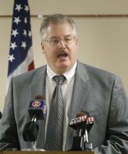 Calumet County District Attorney Ken Kratz reads from a prepared statement announcing that he will step down from his position during a news conference at the Calumet County Courthouse on Friday in Chilton, Wis.