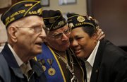 Former U.S. Marine Morningstar Vancil, right, is hugged by Robert C. Potter after speaking with a reporter Tuesday at the Alexander Hamilton American Legion Post 448 office in San Francisco. According to its website, the Alexander Hamilton Post 448 is the only post whose membership is predominantly gay, lesbian, bisexual and transgendered.