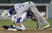 Kansas City second baseman Mike Aviles (30) lands on top of Detroit’s Johnny Damon on a force out to the end the game. The Royals beat the Tigers, 9-6, on Tuesday in Detroit.