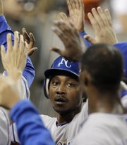 Kansas City’s Jarrod Dyson is congratulated after scoring on a Mike Aviles single in the fifth inning.