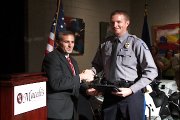 Interim Police chief Tarik Khatib, left, presents a Commendation Award to Officer David Ernst at the police department’s graduation ceremony Friday night at Maceli’s, 1031 N.H.