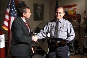 Interim Police chief Tarik Khatib, left, presents a Commendation Award to Officer Trent McKinley at the police department’s graduation ceremony Friday night at Maceli’s, 1031 N.H.