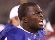 Kansas’ Olaitan Oguntodu encourages his teammates in this file photo from Sept. 25. Oguntodu has moved from safety to linebacker, where he is expected to play Saturday at iowa State.