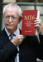 Keith Jeffery poses with his book “ MI6: The History of the Secret Intelligence Service 1909-1949,” after a news conference to launch the book Tuesday at the Foreign and Commonwealth Office in London. Jeffery is the first to be granted complete access to the MI6 archives for the period of history covered by the book.