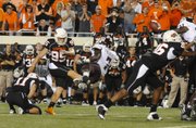 Oklahoma State’s Dan Bailey (95) kicks the winning 40-yard field goal as time expires against Texas A&M, lifting OSU to a 38-35 victory Thursday in Stillwater, Okla.
