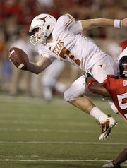 Texas quarterback Garrett Gilbert (7) is sacked by Texas Tech defender Brian Duncan during their game Sept. 18 in Lubbock, Texas. Saturday, Gilbert will lead UT against rival Oklahoma in Dallas.