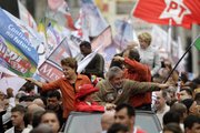 From the top of a vehicle, President Luiz Inacio Lula da Silva, right, Workers Party presidential candidate Dilma Rousseff, left, and first lady Marisa Leticia, bottom, wearing a red hat, greet supporters during a campaign rally Saturday in Sao Bernardo do Campo, Sao Paulo state, Brazil. Brazil will hold general elections today.