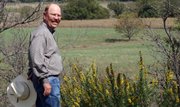 J.C. Barr, the auctioneer and broker for the sale of the White Ranch overlooks one of the highest points on the ranch near the Indian Guide monument, near Peabody in this Sept. 22 photo.