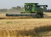A farmer harvests wheat near Norwich. Demand and prices for U.S. wheat have soared since Russia announced it would ban wheat exports in August.