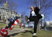 Margie Phelps, daughter of the Rev. Fred Phelps of the Westboro Baptist Church in Topeka, kicks a U.S. flag on the grass outside the Colorado State Capitol during a rally for the “Right to Rest in Peace” rally in Denver in this March 23, 2006, file photo. Phelps is set to go before the U.S. Supreme Court today to represent her church in a case that tests the scope of free speech protections under the Constitution’s First Amendment.