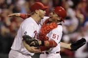 Philadelphia starting pitcher Roy Halladay, left, celebrates with catcher Carlos Ruiz after throwing a no-hitter against the Reds on Wednesday in Philadelphia.