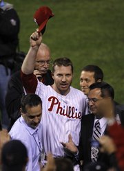 Philadelphia pitcher Roy Halladay tips his hat to the crowd after throwing a no-hitter. The Phillies blanked the Reds, 4-0, on Wednesday in Game 1 of a National League division series in Philadelphia.